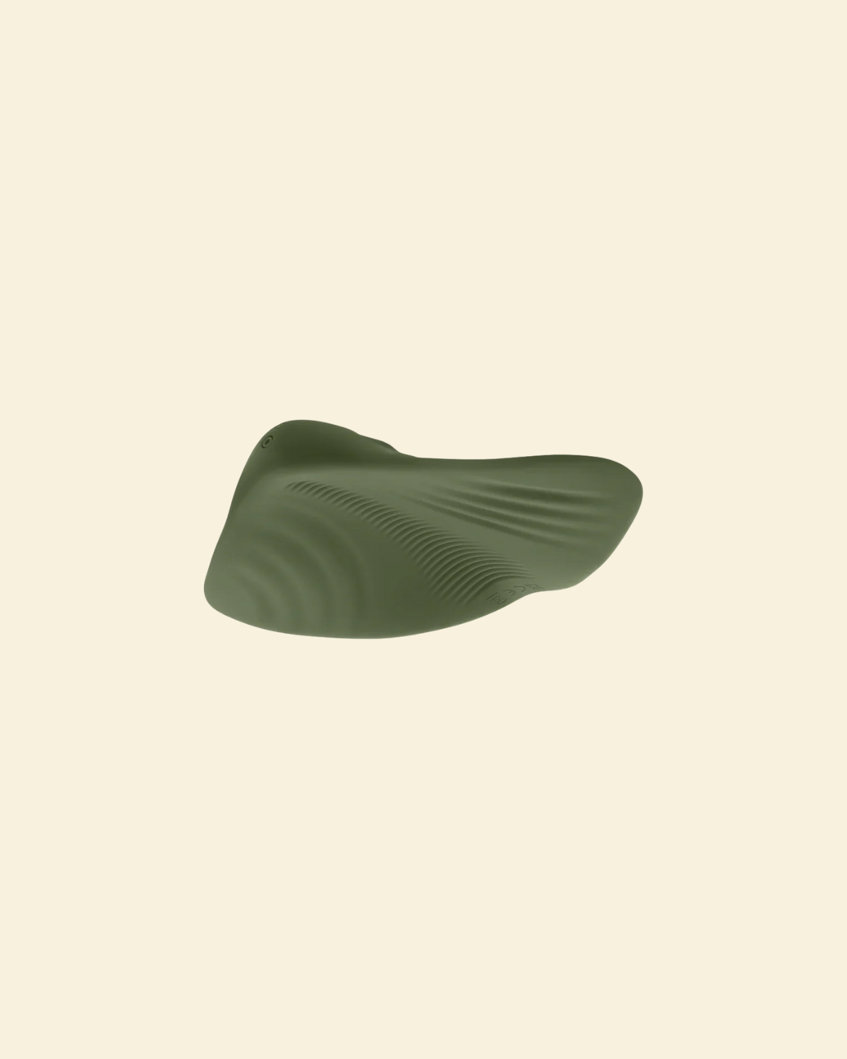 Bottom view of the green pleasure pad on a beige background