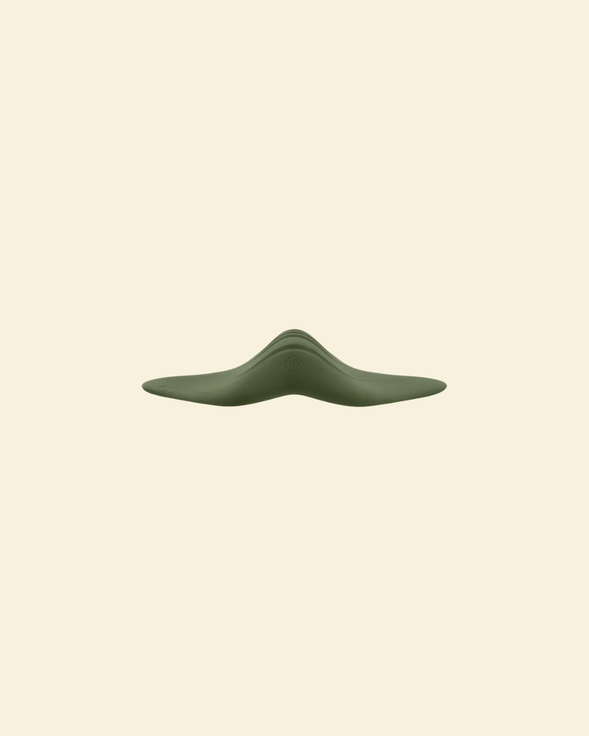 Sideview of the green pleasure pad on a beige background