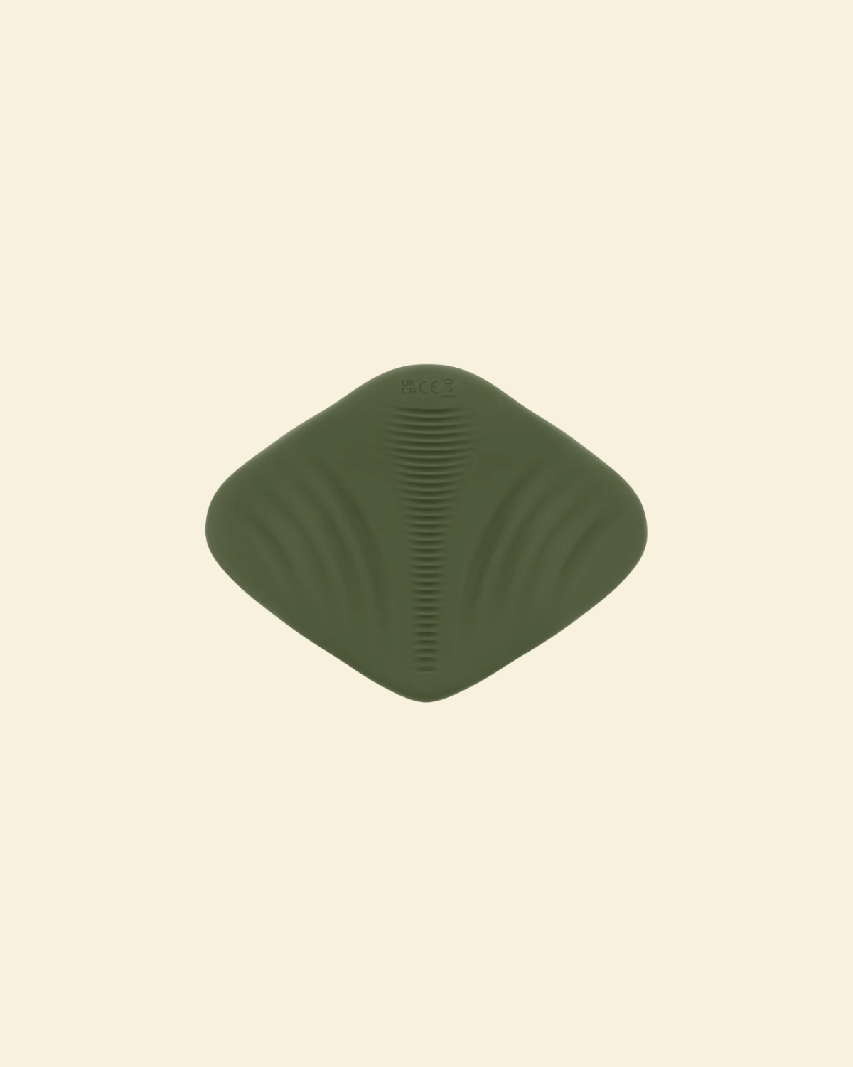 View of the bottom of a green pleasure pad on a beige background