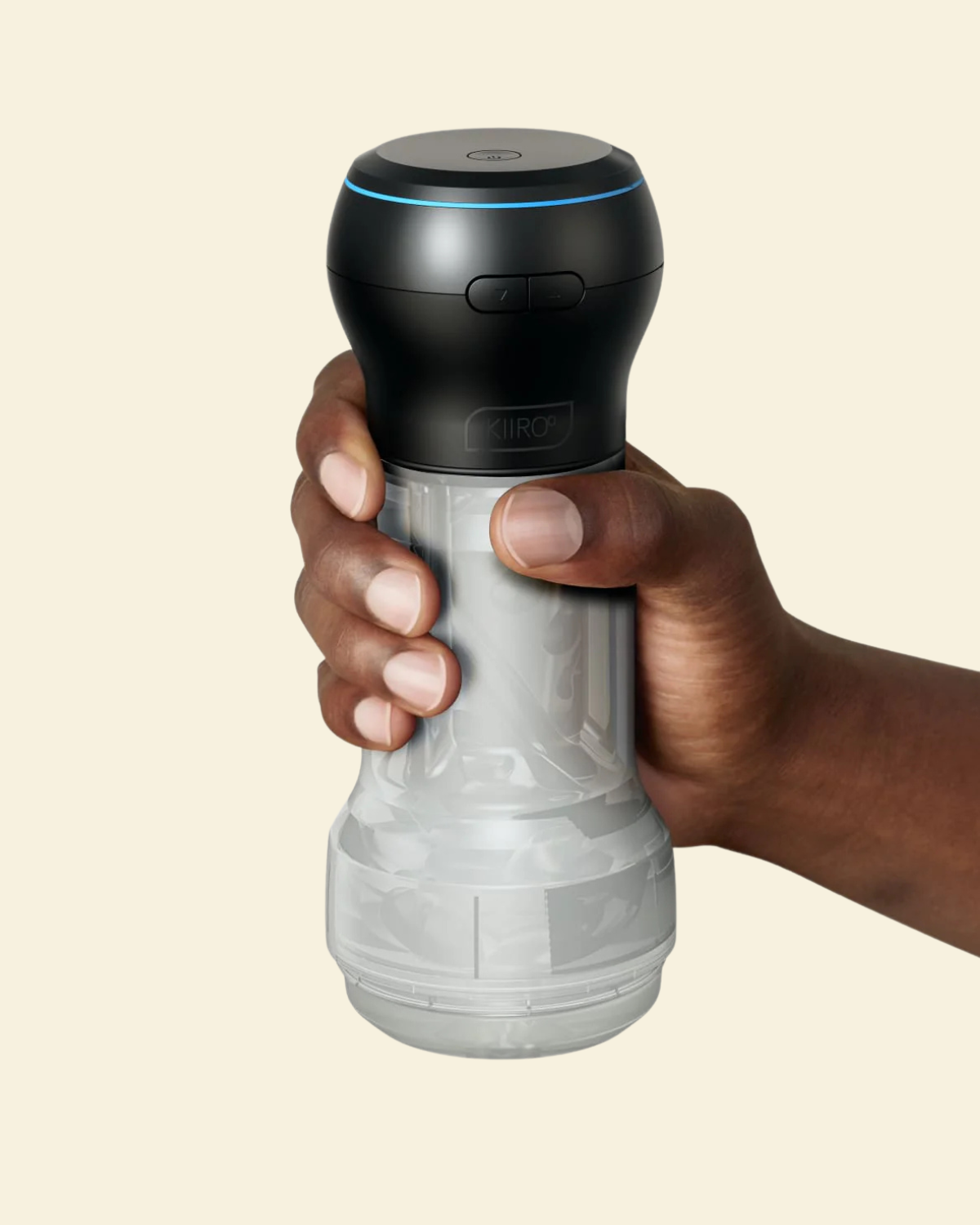 Black and clear suction and stroking masturbator held by a hand