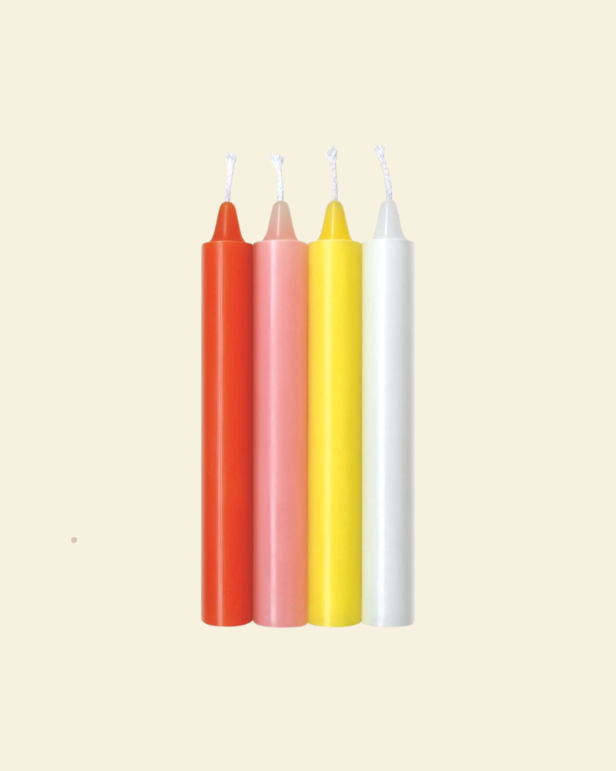 Four colorful drip candles on a beige background