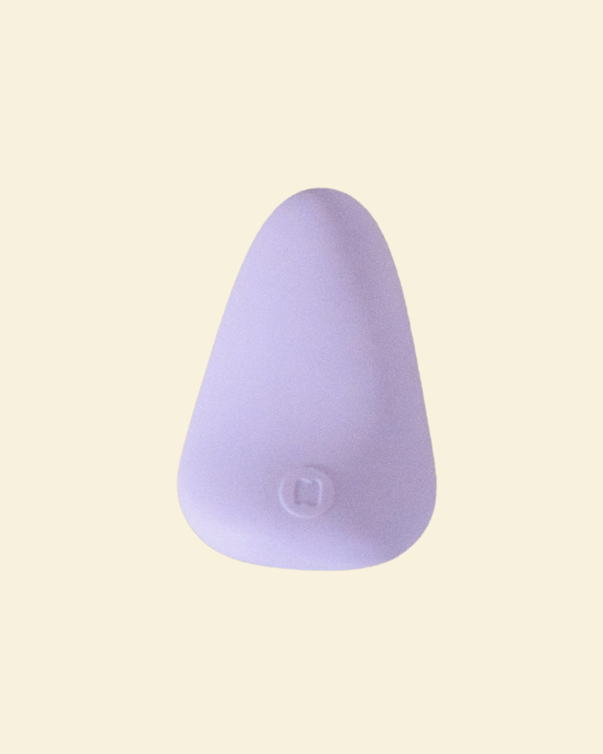Purple silicone palm vibrator on a beige back ground