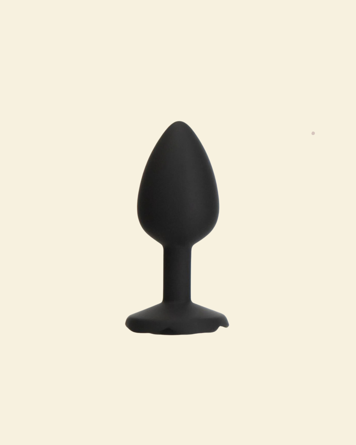 Black silicone butt plug on a beige background