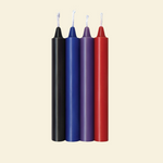 Four colorful drip candles on a beige background