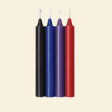 Four colorful drip candles on a beige background