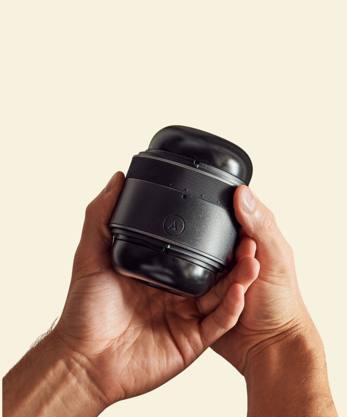 2 hands holding a black adjustable non-vibrating stroker 