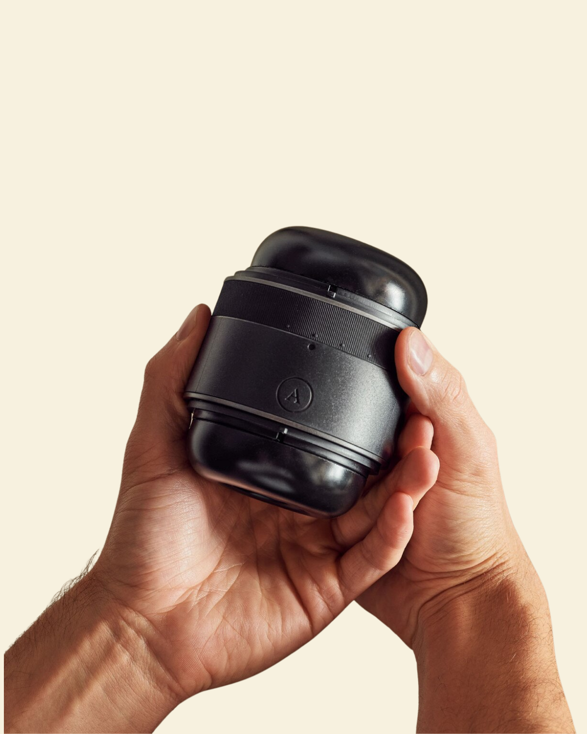 2 hands holding a black adjustable non-vibrating stroker 