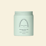 A mint green jar of 'The Department of Bed Inventions' Massage Body Jelly, centered on a solid cream background.