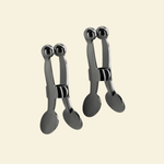 Set of gun metal nipple clamps on a beige background