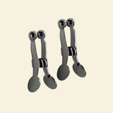 Set of gun metal nipple clamps on a beige background