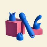 Blue silicone wand vibrator on pink blocks against a beige background