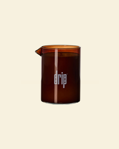 Brown glass vessel containing a drip massage candle
