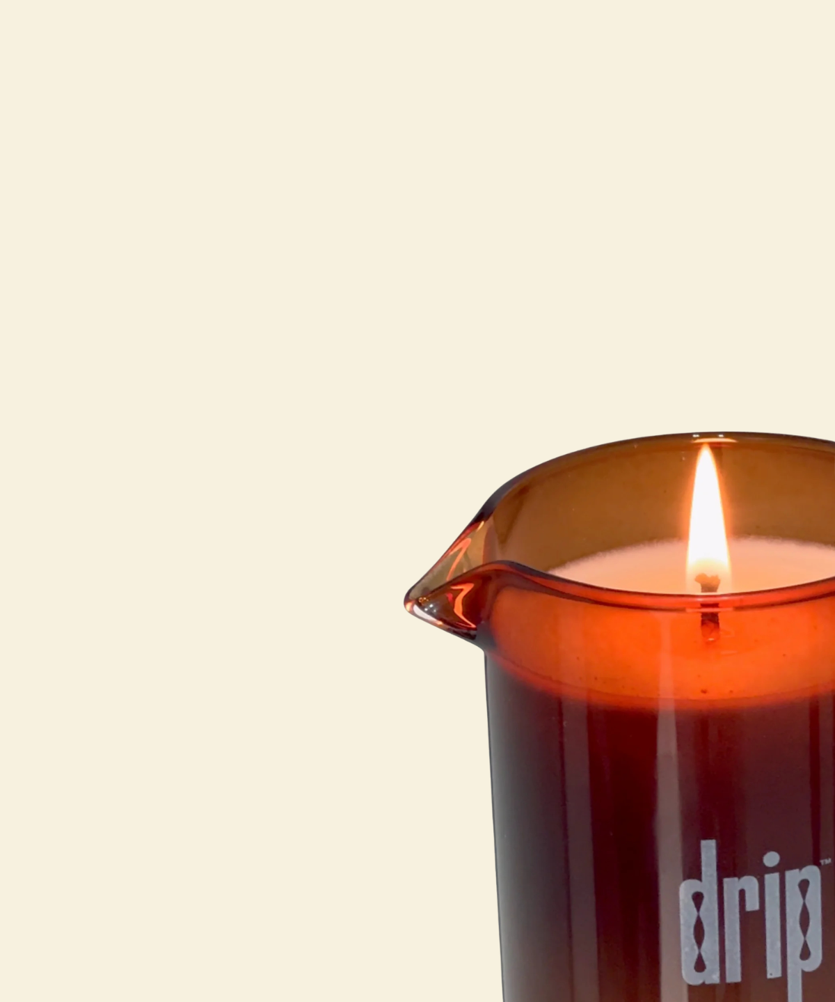 Brown glass vessel containing a drip massage candle