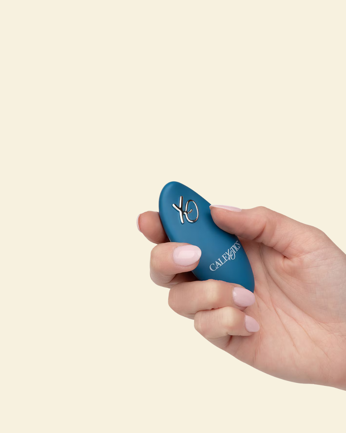 Hand holding a blue remote controller for the grinding vibrator 