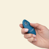 Hand holding a blue remote controller for the grinding vibrator 