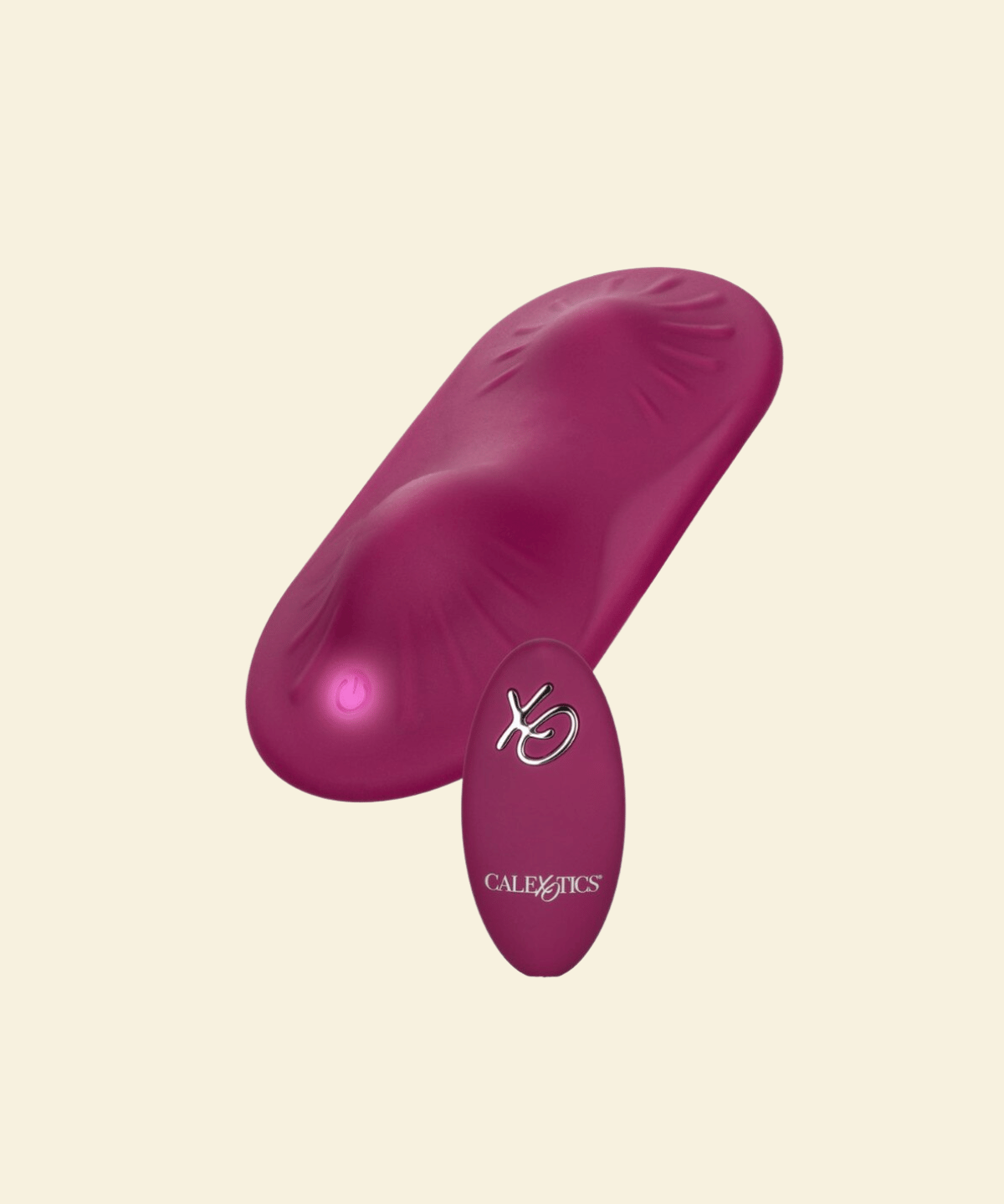 A magenta pink personal massager with a curved, textured body and a small oval remote control, both featuring the 'CalExotics' brand logo, set against a solid cream background.