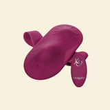 A magenta silicone intimate accessory with a main curved body, a smaller attached flap, and a small white logo and brand name reading CalExotics, shown on a plain warm cream background.