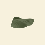 Bottom view of the green pleasure pad on a beige background