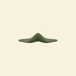 Sideview of the green pleasure pad on a beige background
