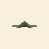 Sideview of the green pleasure pad on a beige background