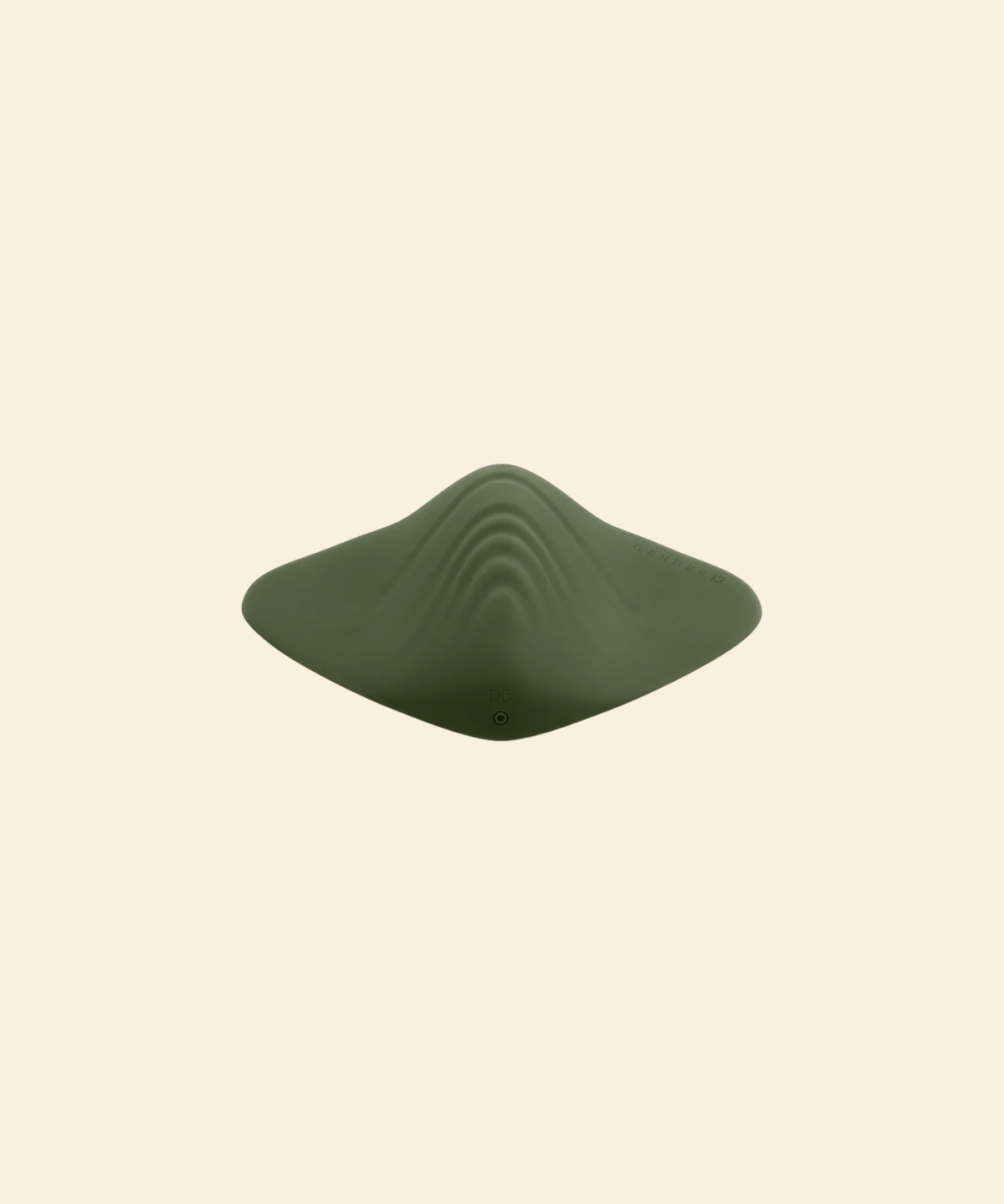 top view of a green pleasure pad on a beige background