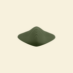 top view of a green pleasure pad on a beige background