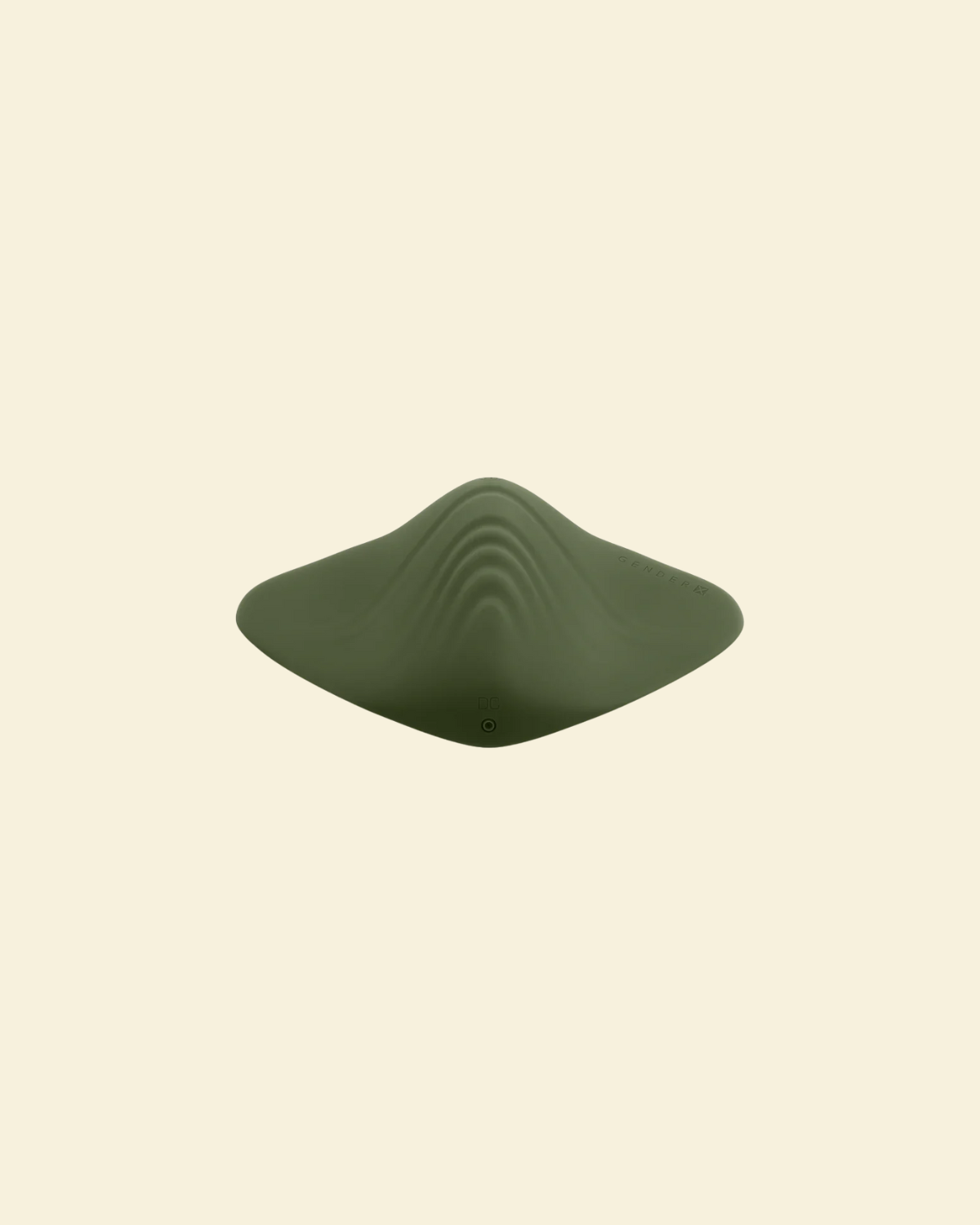 top view of a green pleasure pad on a beige background