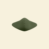 top view of a green pleasure pad on a beige background