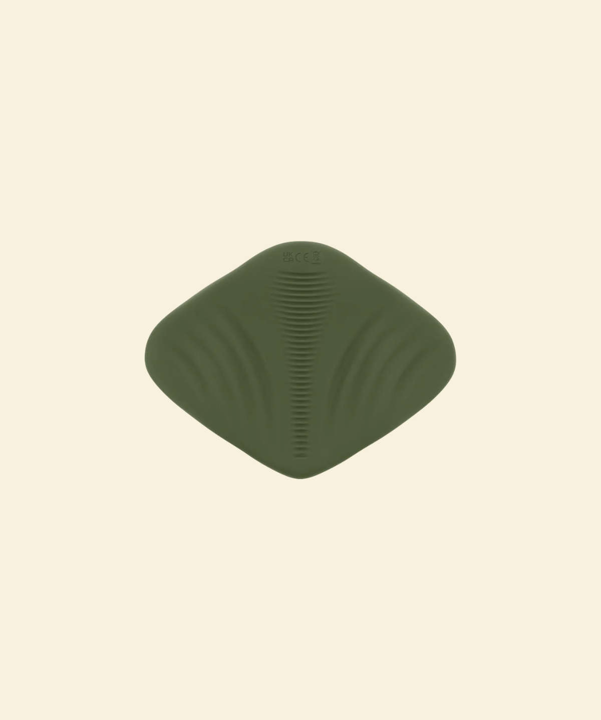 View of the bottom of a green pleasure pad on a beige background