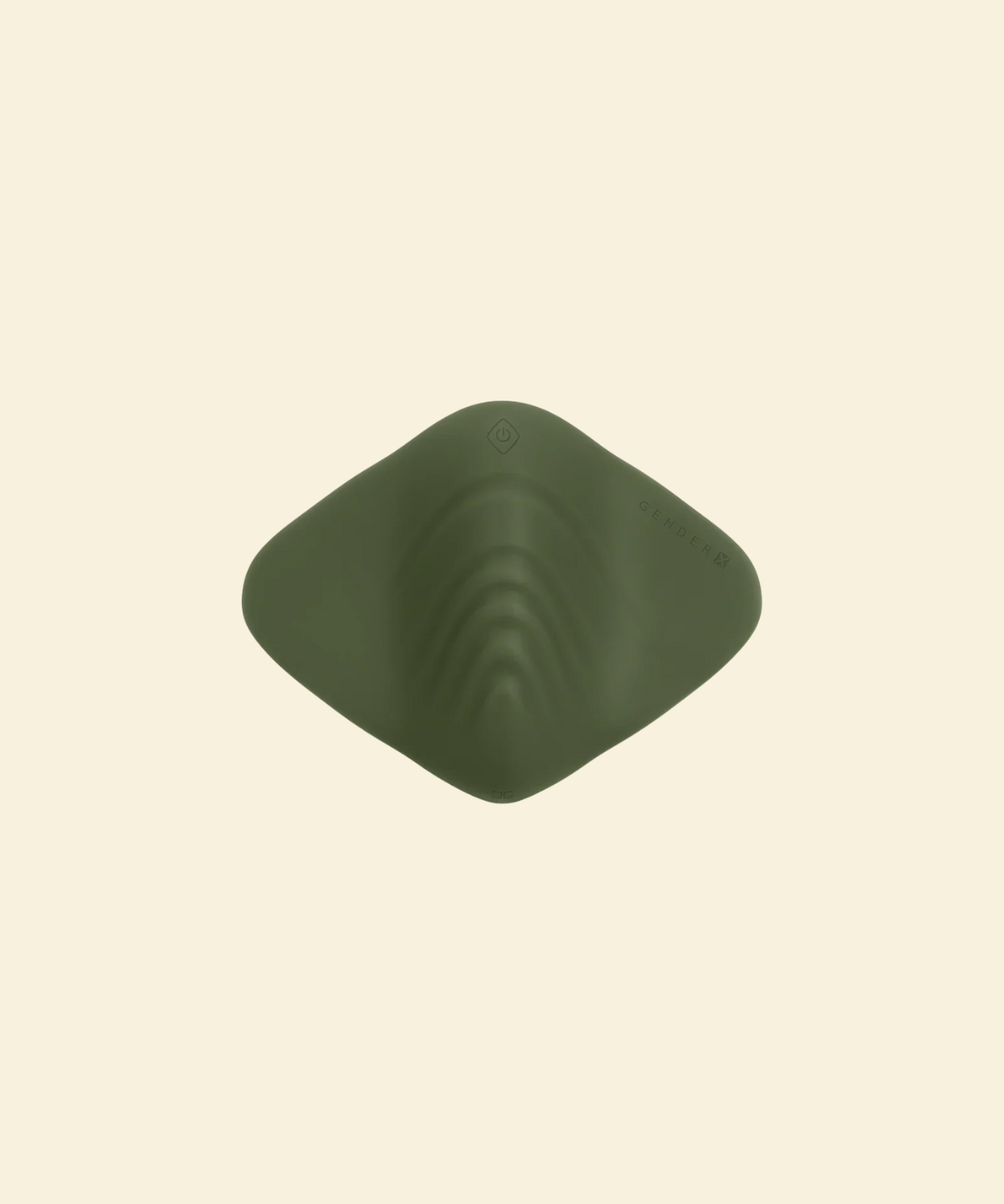 Top view of a green pleasure pad on a beige background