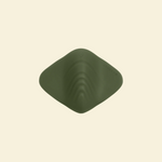 Top view of a green pleasure pad on a beige background