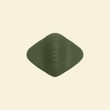 Top view of a green pleasure pad on a beige background