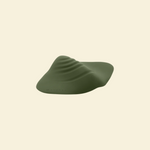 Green pleasure pad on a beige background