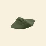 Green pleasure pad on a beige background