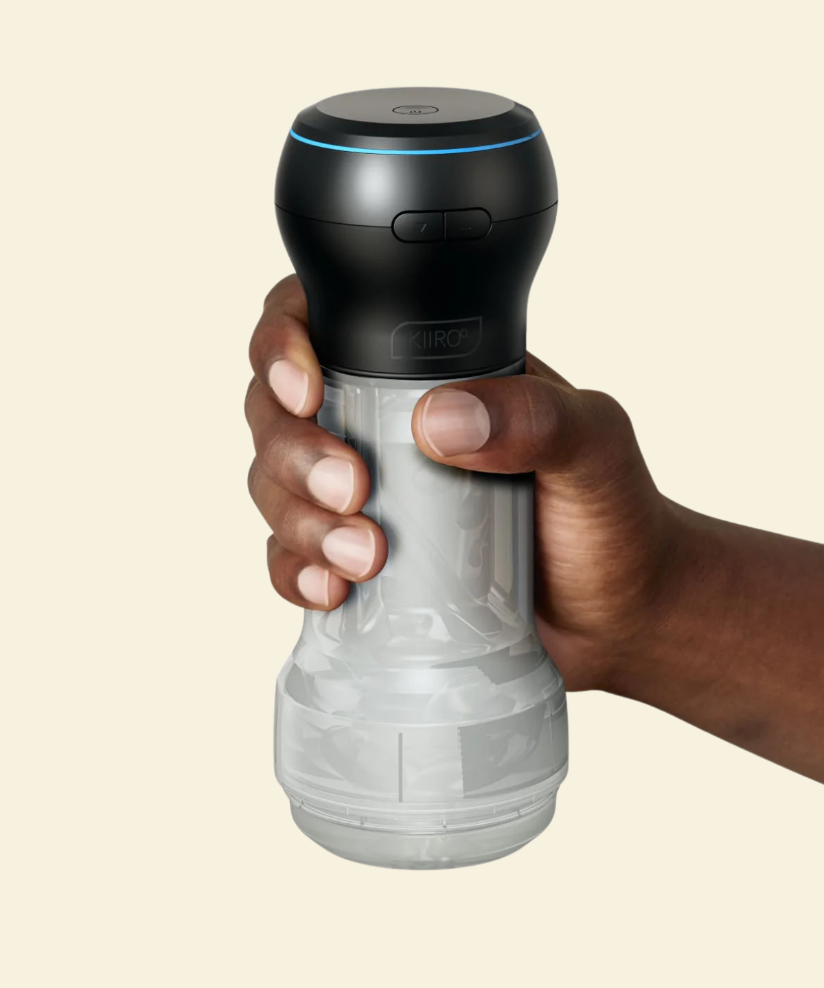 Black and clear suction and stroking masturbator held by a hand