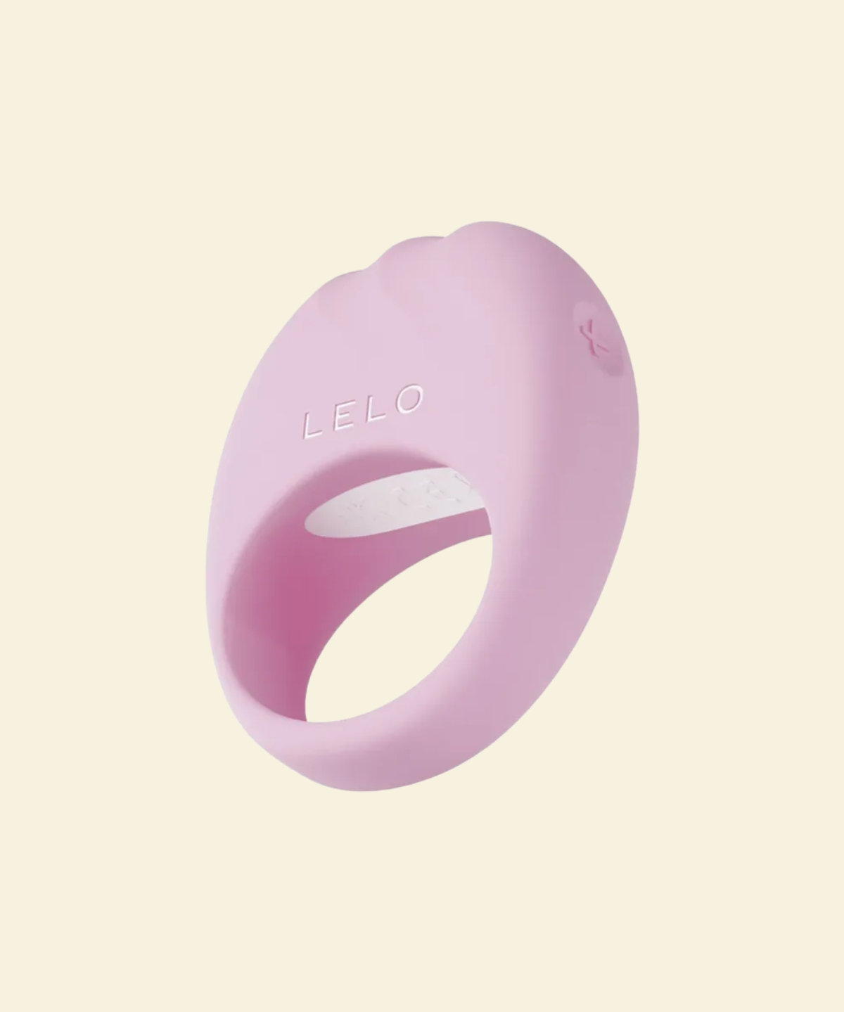 Pink silicone ring with 'LELO' branding on a light beige background