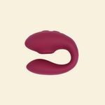Plum colored blended stimulation vibrator on a beige background