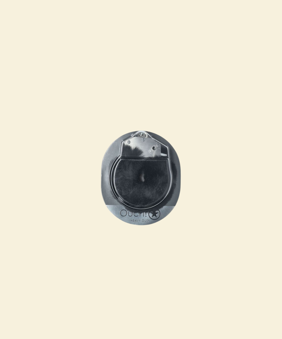 Metallic circular object on a beige background