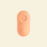 A coral colored tapping and vibrating massager 