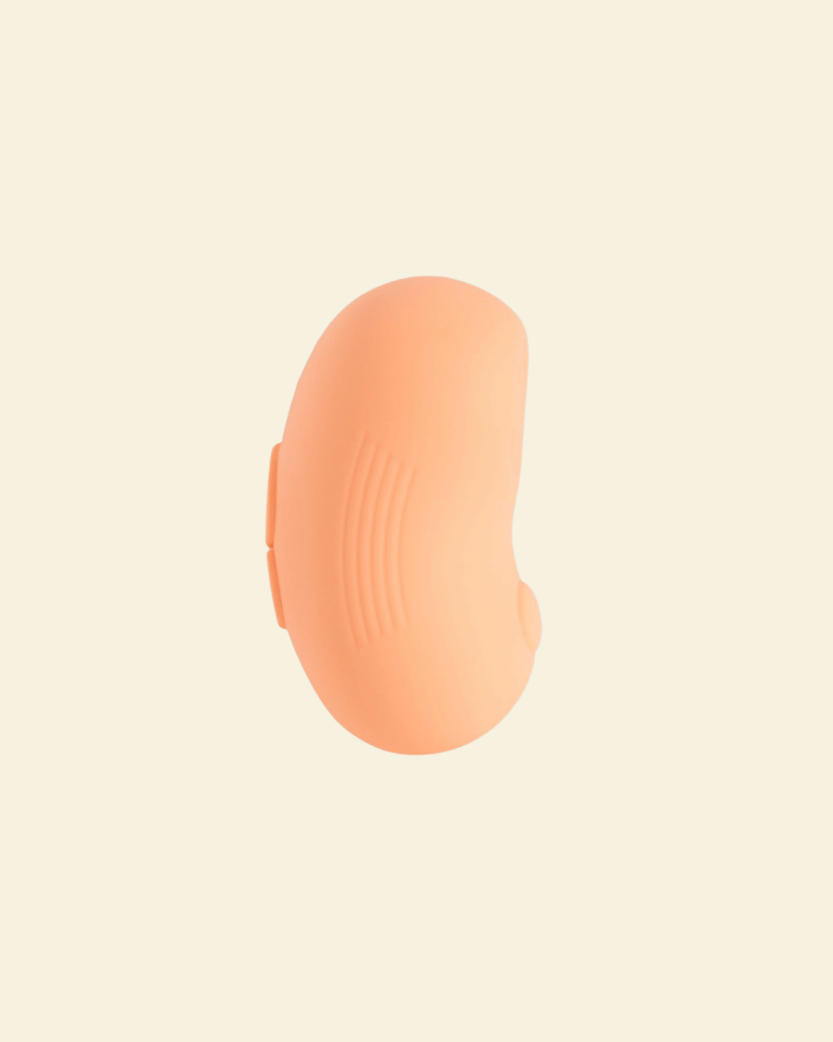 Side view of a coral colored tapping and vibrating massager 
