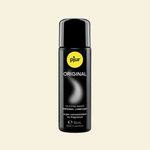 Black bottle of pjur Original lubricant on a beige background
