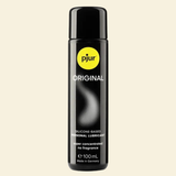 Bottle of pjur Original lubricant on a beige background