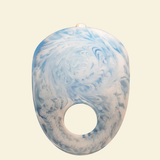 Blue and white marbled object on a beige background