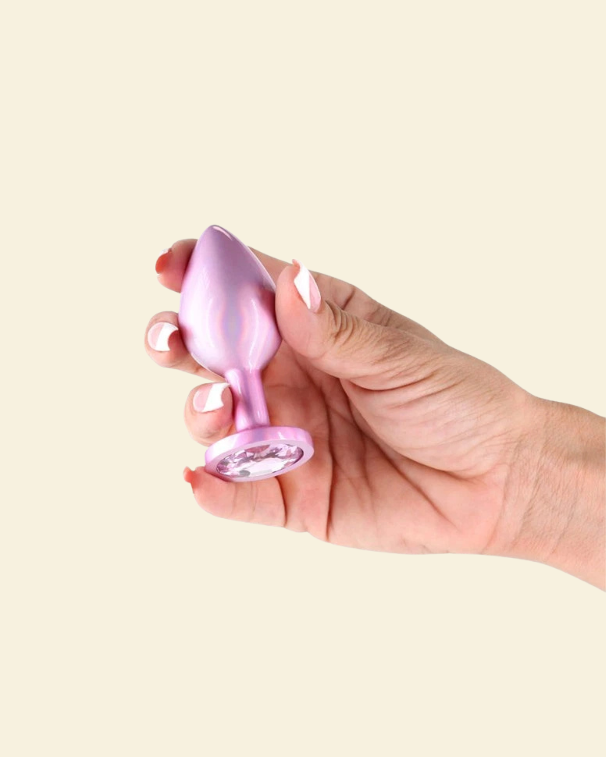 hand holding a pink butt plug
