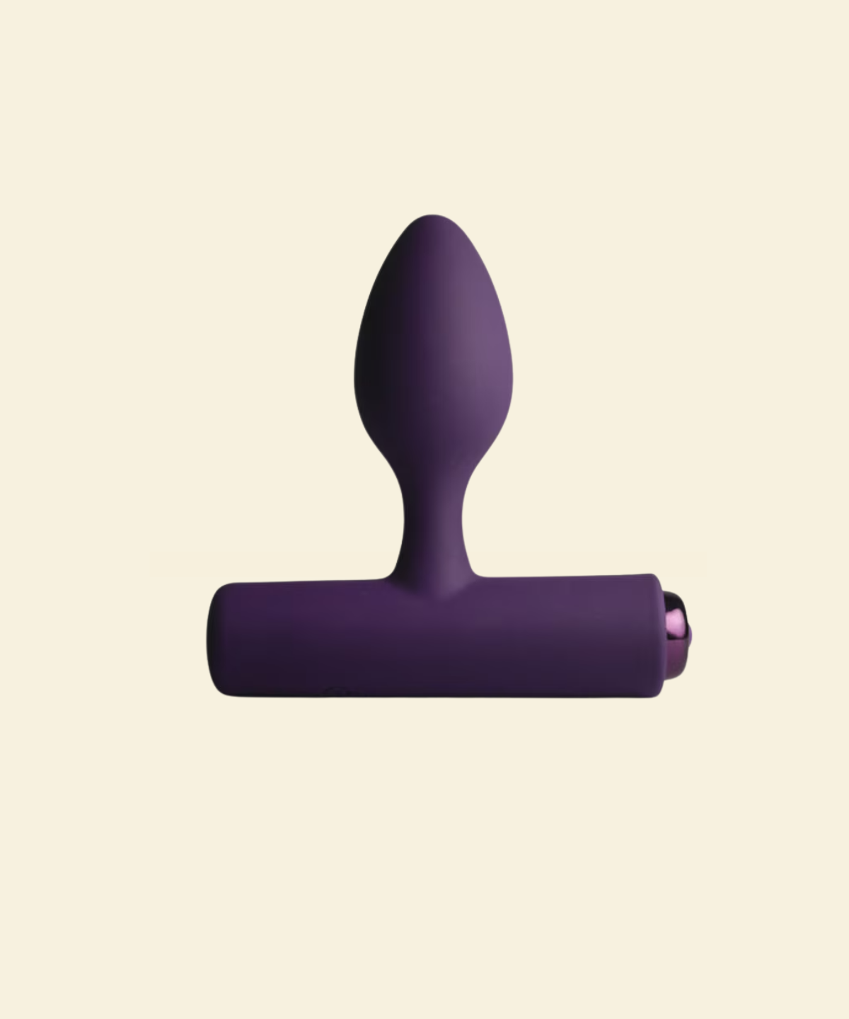 Purple vibrating butt plug on beige background