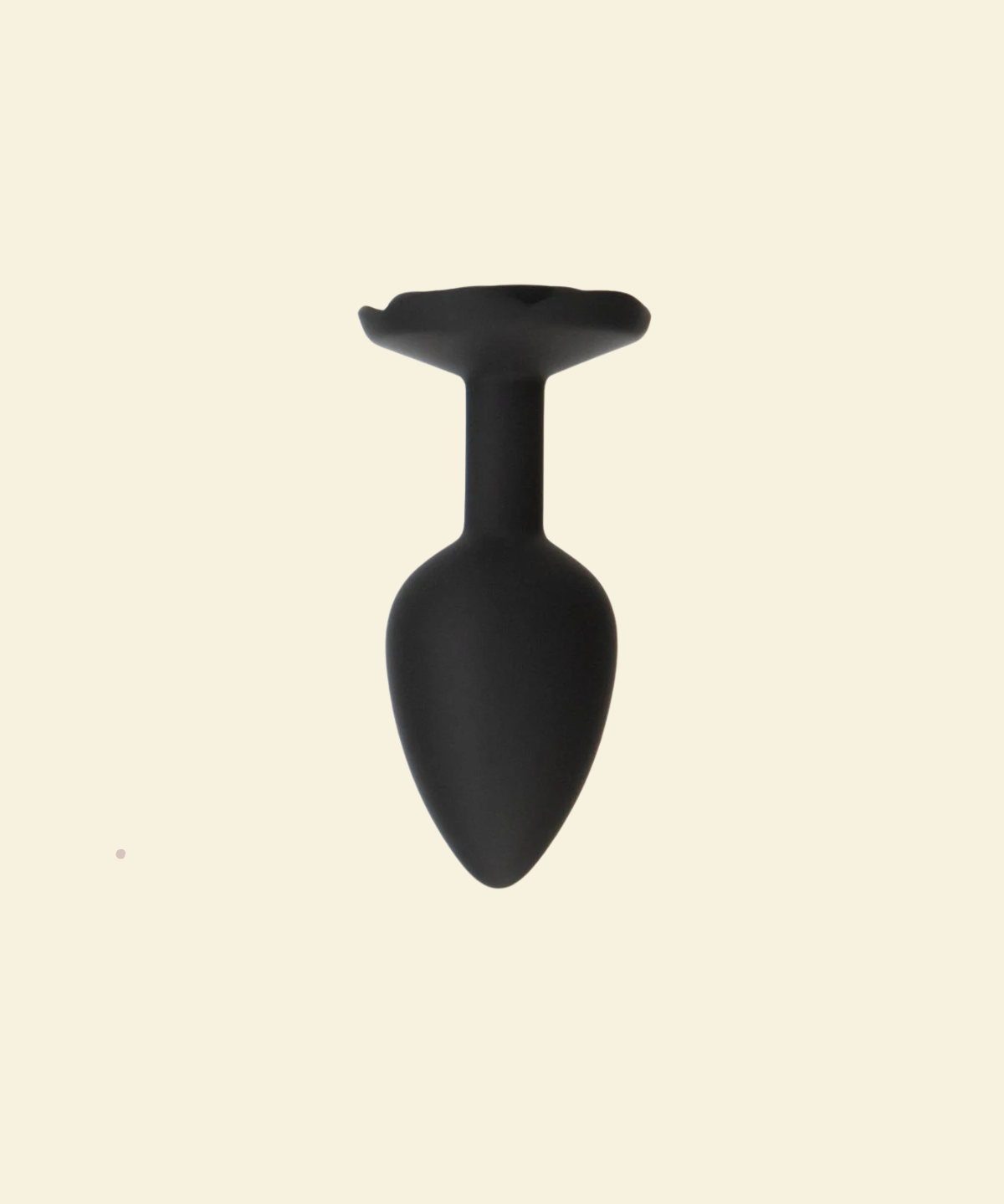 Black silicone butt plug on a beige background