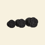 Three rose shaped bases of black silicone buttplugs