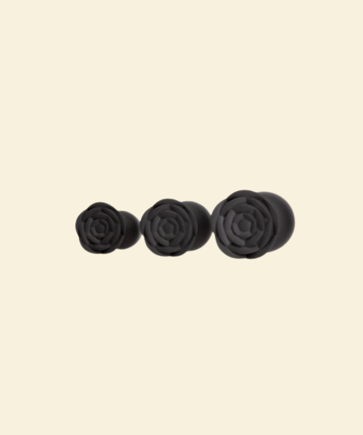 the rose bases of 3 black silicone buttplugs in different sizes