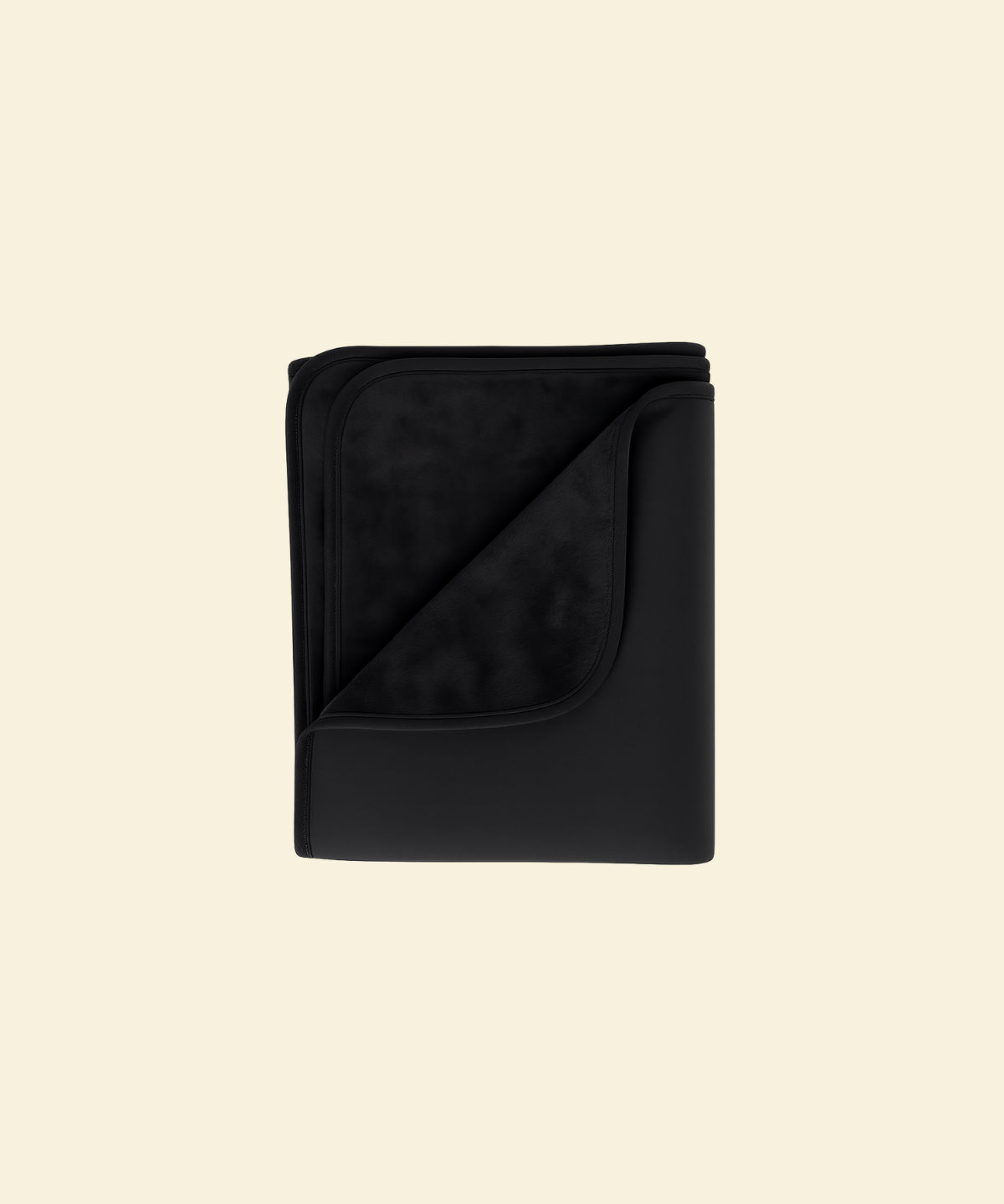 Black waterproof splash blanket folded on a beige background