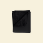 Black waterproof splash blanket folded on a beige background